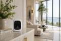White ECHO cold-air diffuser on a marble kitchen counter in a bright open-plan living room with ocean view