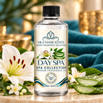 A bottle of Mila Marie Scents Day Spa Spa Collection premium fragrance oil, styled on a marble surface with white lilies, aloe vera slices, and a teal towel in the background.