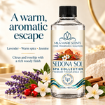 A bottle of Mila Marie Scents 'Sedona Sol' spa collection premium fragrance oil, styled with lavender, white flowers, red berries, and cinnamon sticks on a warm beige marble surface with text overlays describing the scent profile.