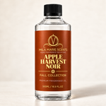 Apple Harvest Noir luxury fragrance oil bottle with dark spiced apple and autumn backdrop