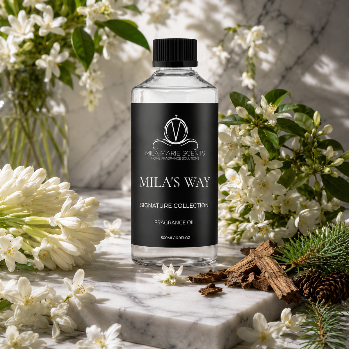Mila's Way fragrance oil on marble with florals
